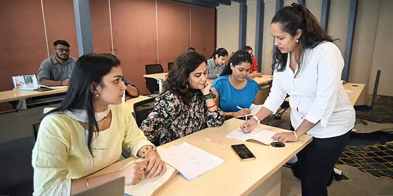 A dedicated academic consultant assisting a PhD scholar with thesis structuring and research methodology in a professional setting.